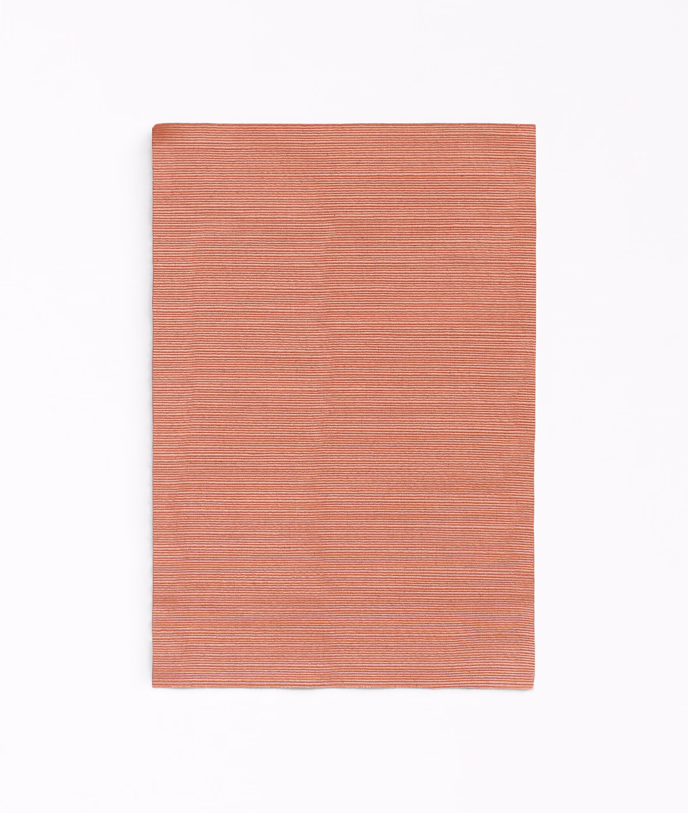 Dusty coral-terracotta curtain fabric with fine horizontal ribbed texture