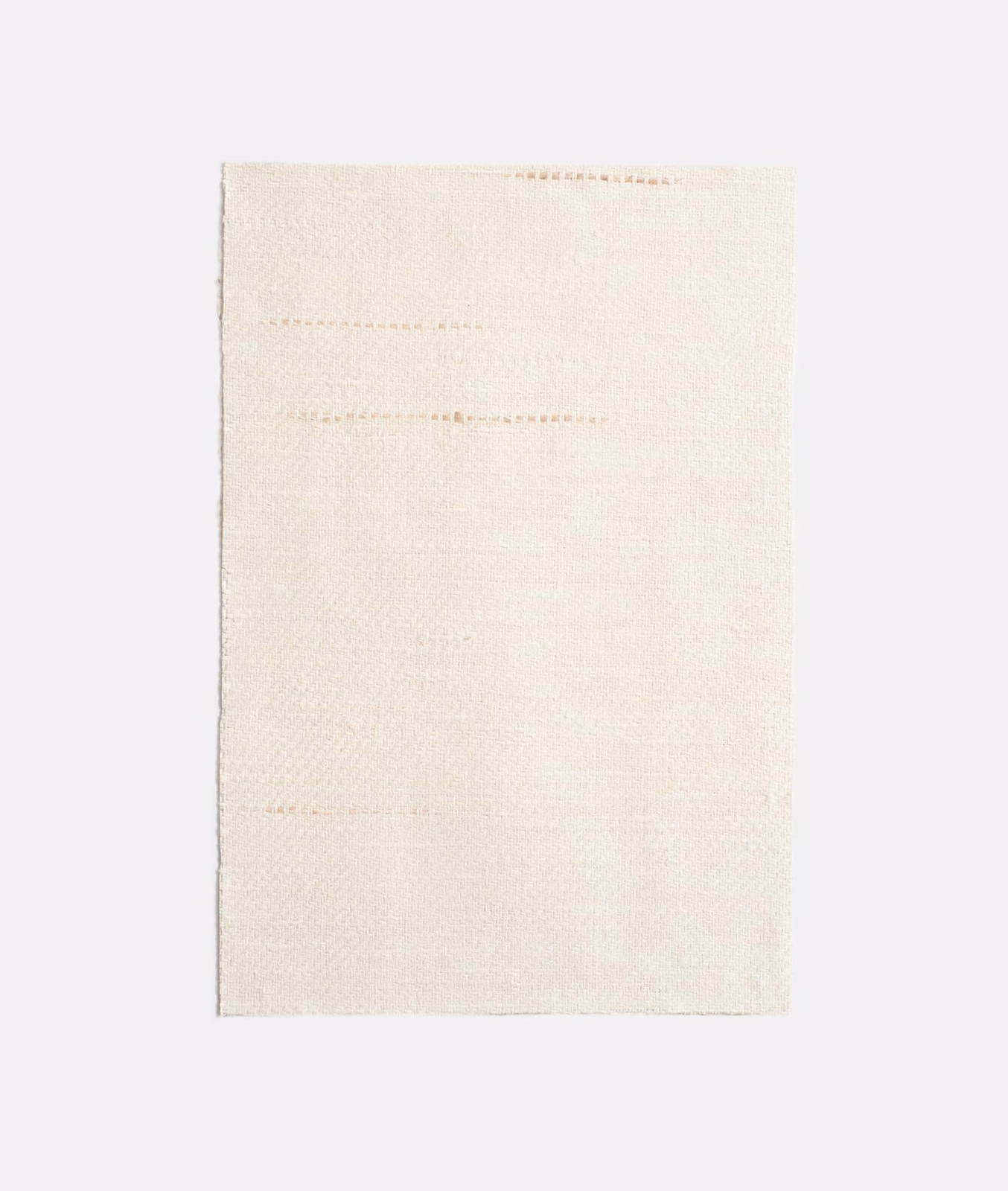 Pale ivory woven curtain fabric with faint horizontal slub lines
