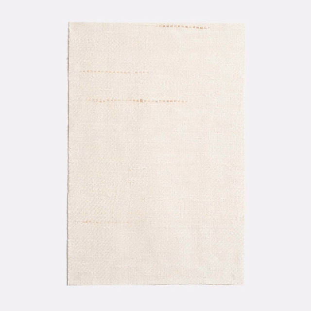 Pale ivory woven curtain fabric with faint horizontal slub lines