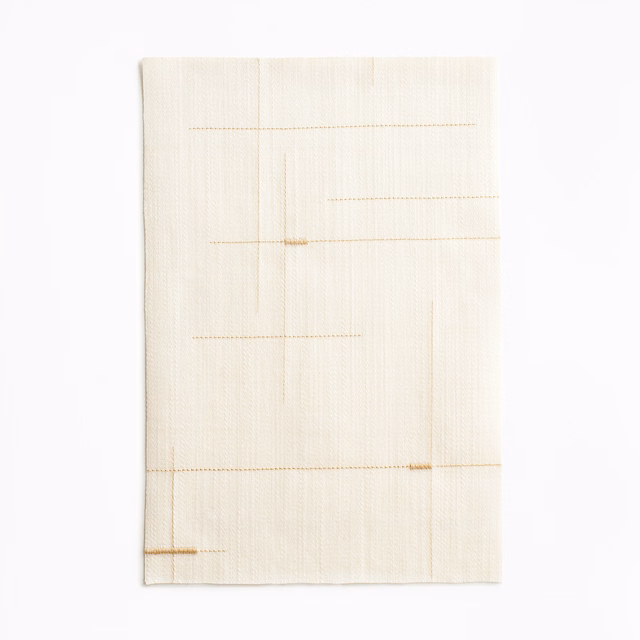 Warm ivory woven curtain fabric with fine grid lines and subtle gold accents