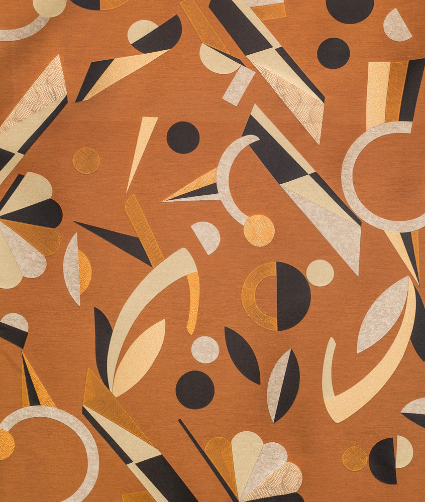 Copper-toned textile with cream arcs, black shapes, ochre lines and rounded motifs