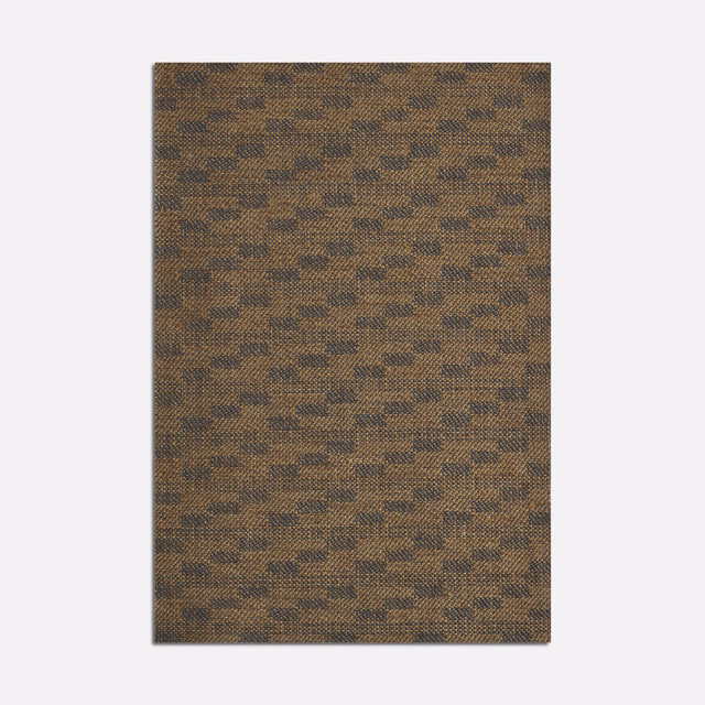 Warm ochre-brown woven fabric with small broken dark diagonal flecks