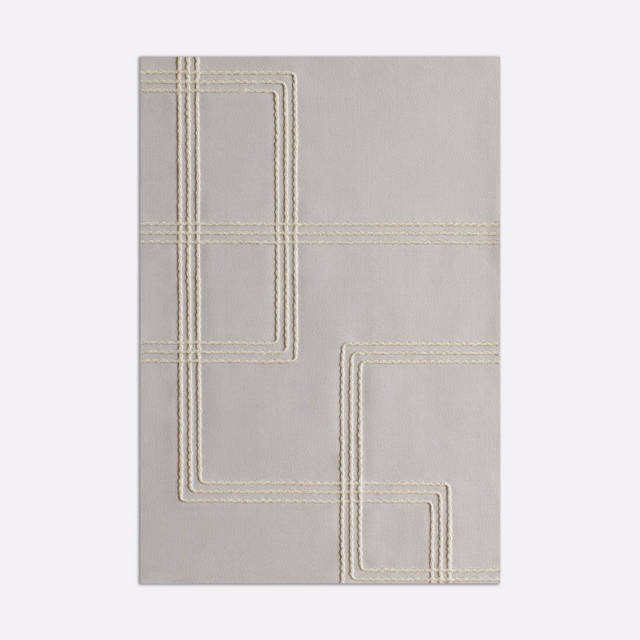 Pale grey fabric with ivory stitched geometric lines forming nested angular panels