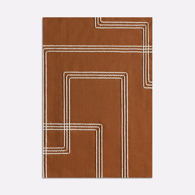 Warm tobacco-brown textile with cream triple-line geometric paths and fine vertical weave