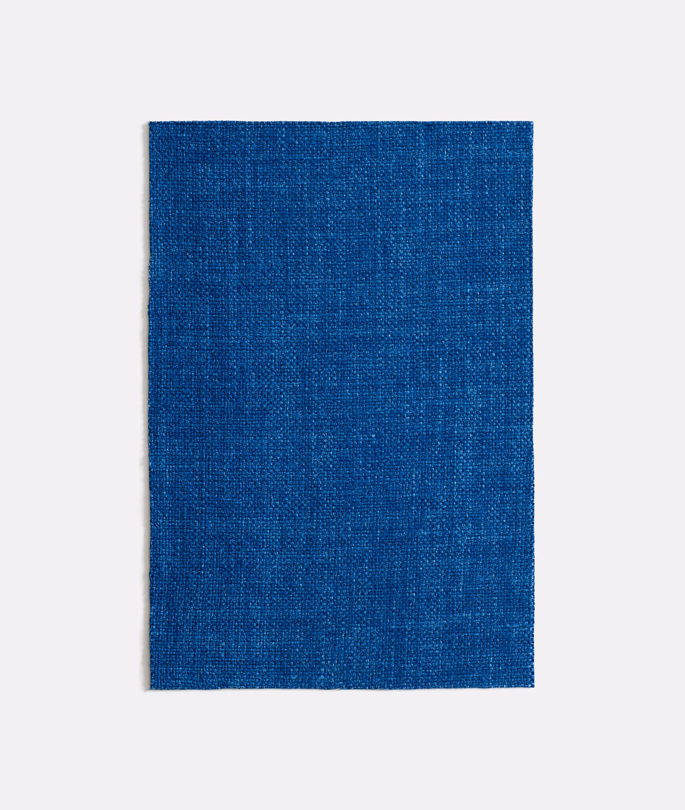 Deep cobalt-blue curtain fabric with a fine, subtly varied woven texture
