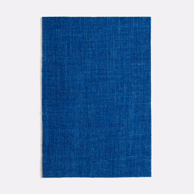Deep cobalt-blue curtain fabric with a fine, subtly varied woven texture