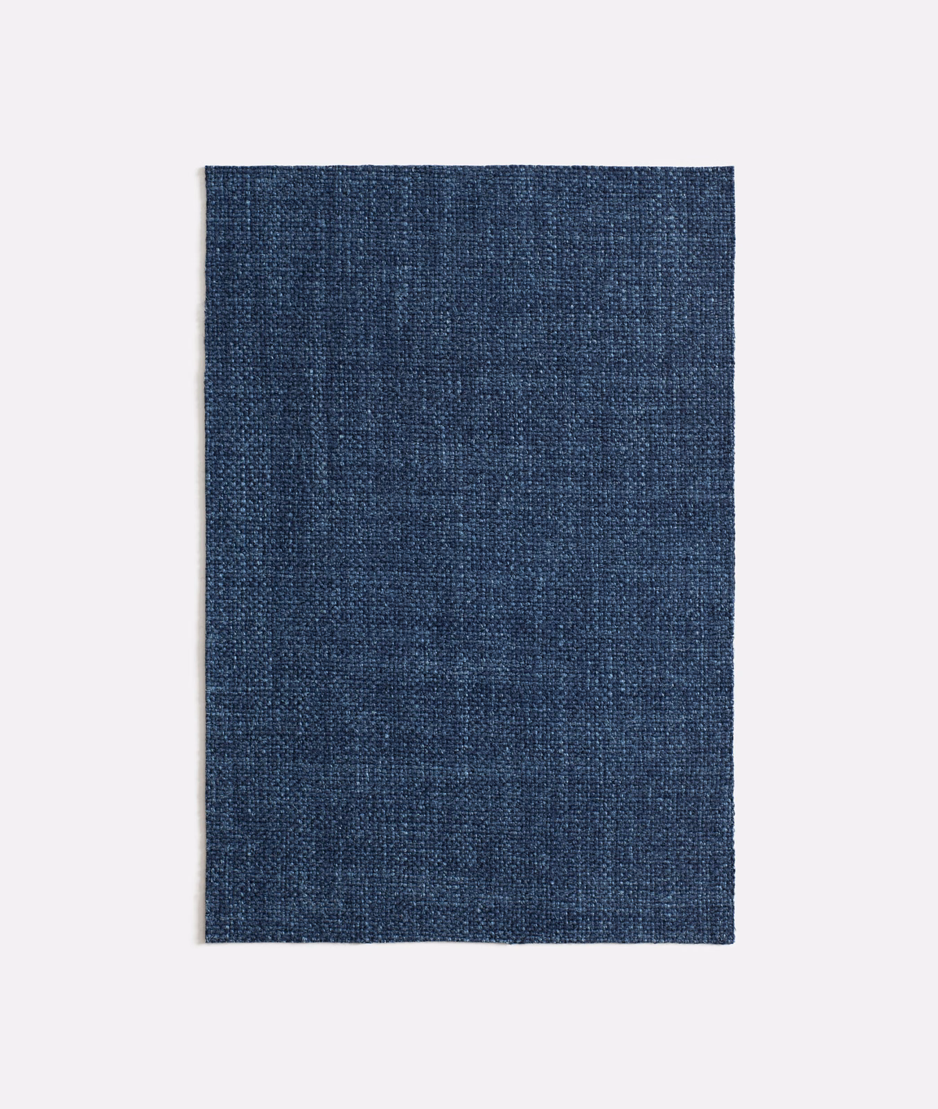 Deep indigo woven textile with subtle vertical tonal variation and fine texture