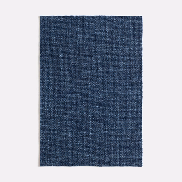 Deep indigo woven textile with subtle vertical tonal variation and fine texture