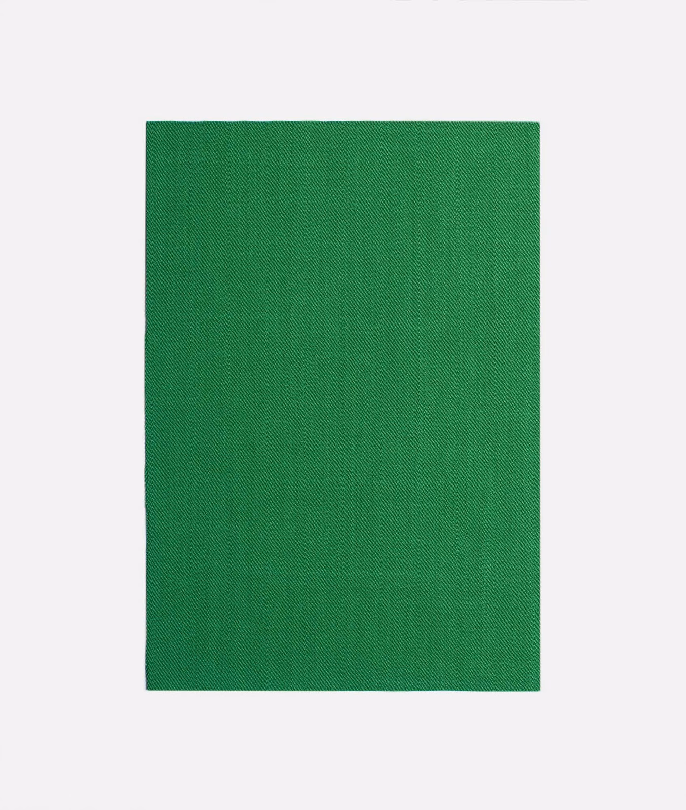 Saturated chlorophyll green curtain textile with a subtle fine woven surface