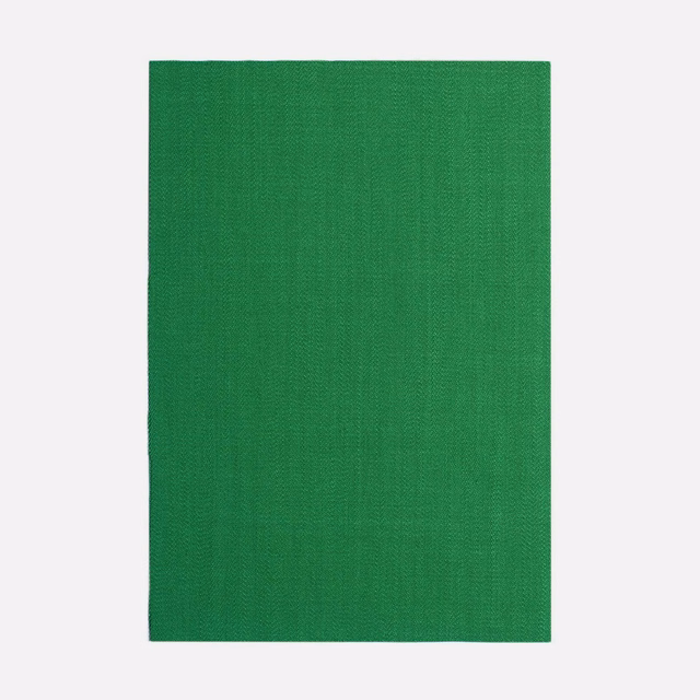Saturated chlorophyll green curtain textile with a subtle fine woven surface