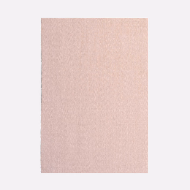 Pale dusty blush pink curtain fabric with a fine vertical woven texture