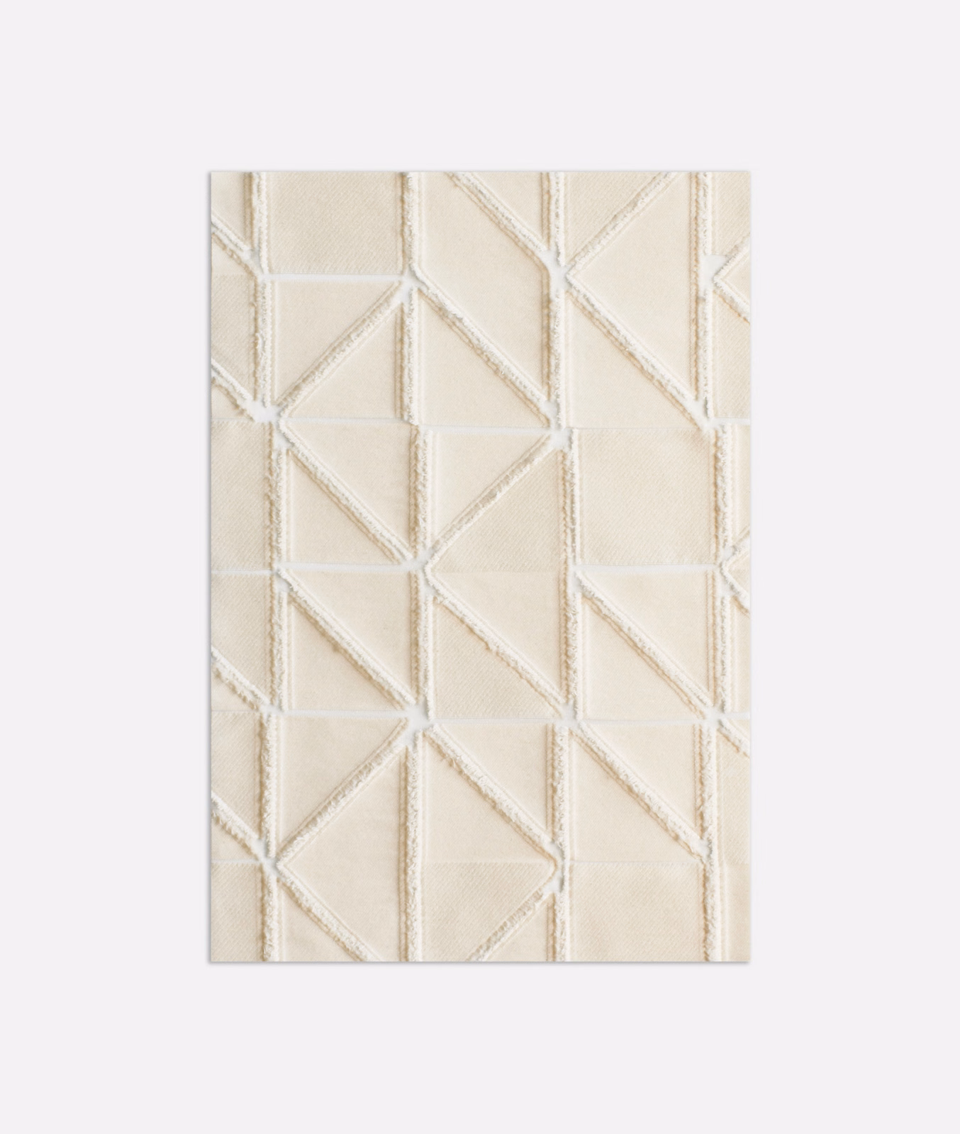 Warm ivory textile with raised angular cream lines forming broken geometric panels
