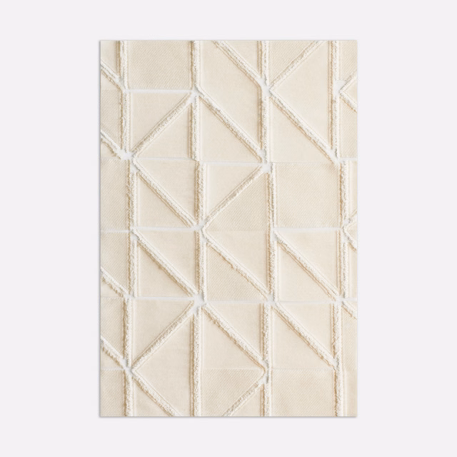 Warm ivory textile with raised angular cream lines forming broken geometric panels