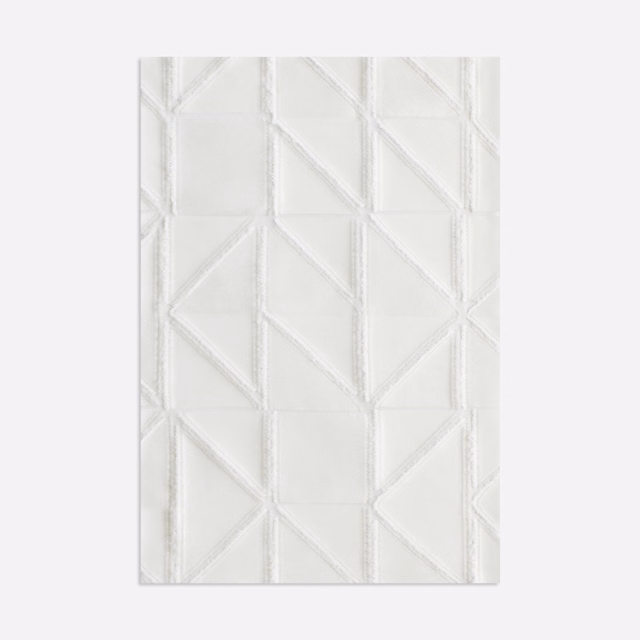 Ivory-white curtain fabric with raised angular panels and fine linear texture