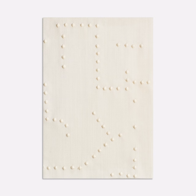 Ivory woven curtain fabric with raised cream dots forming broken geometric lines