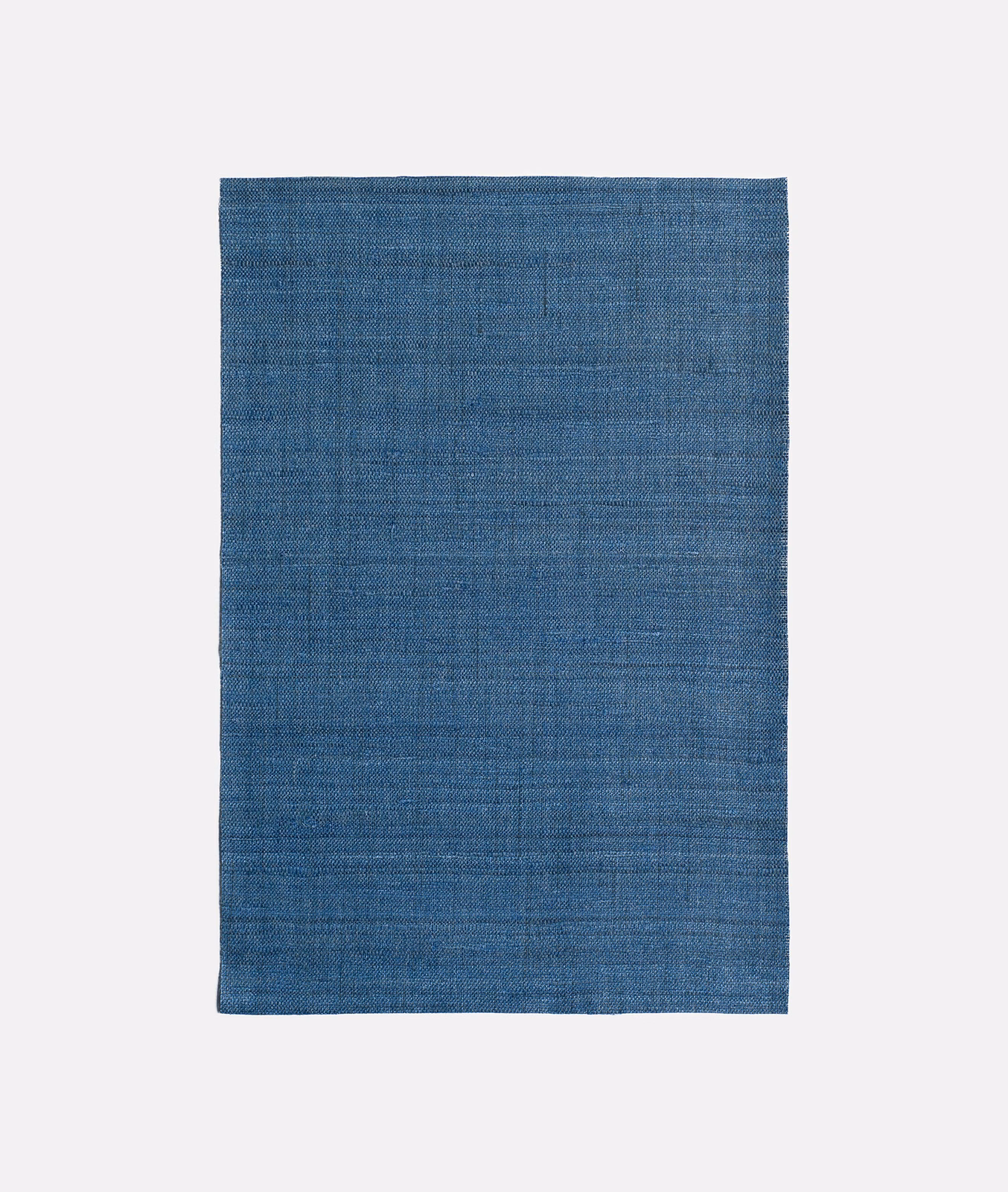 Cool indigo-blue textile with fine horizontal weave and softly mottled surface