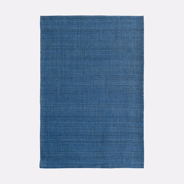 Cool indigo-blue textile with fine horizontal weave and softly mottled surface