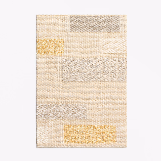 Ivory woven curtain swatch with textured rectangles and muted golden-yellow accents