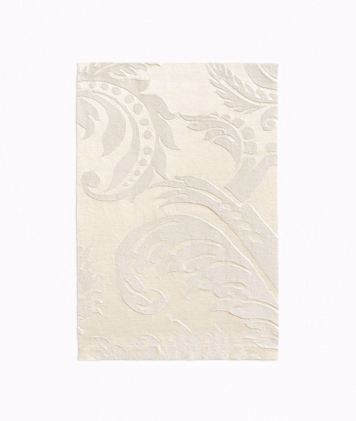 Warm ivory fabric with large tonal damask scrolls and softly textured surface
