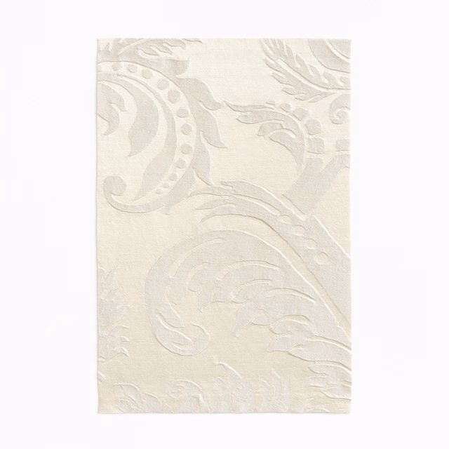Warm ivory fabric with large tonal damask scrolls and softly textured surface