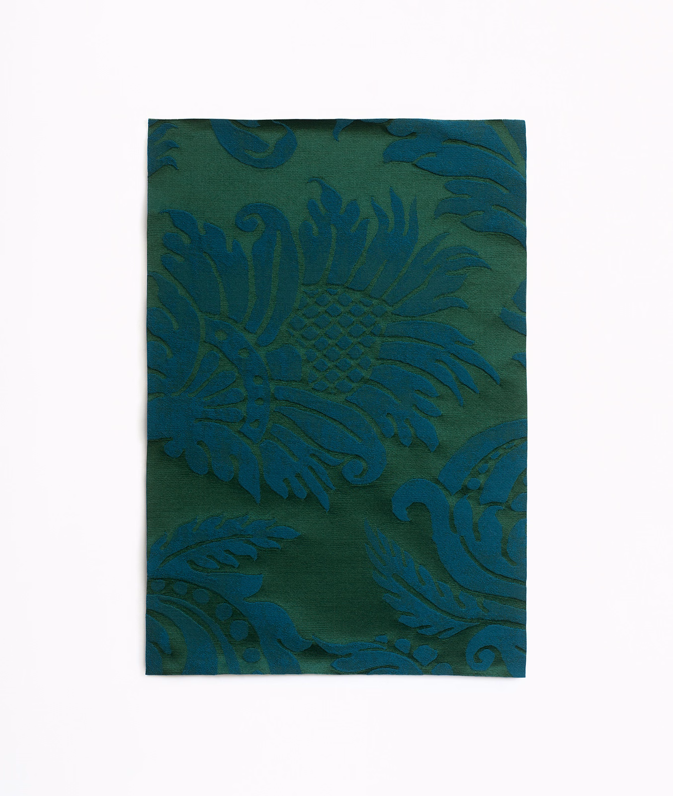 Deep teal-green damask fabric with large curling leaves and fan-shaped floral motifs