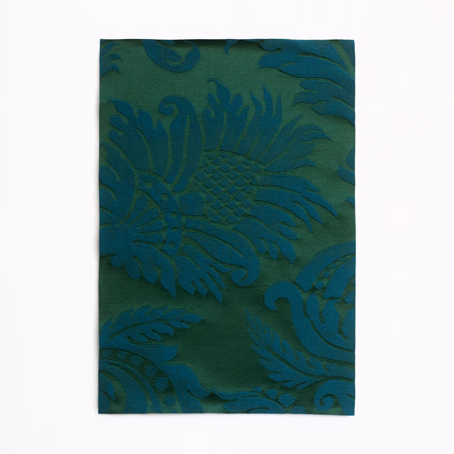 Deep teal-green damask fabric with large curling leaves and fan-shaped floral motifs
