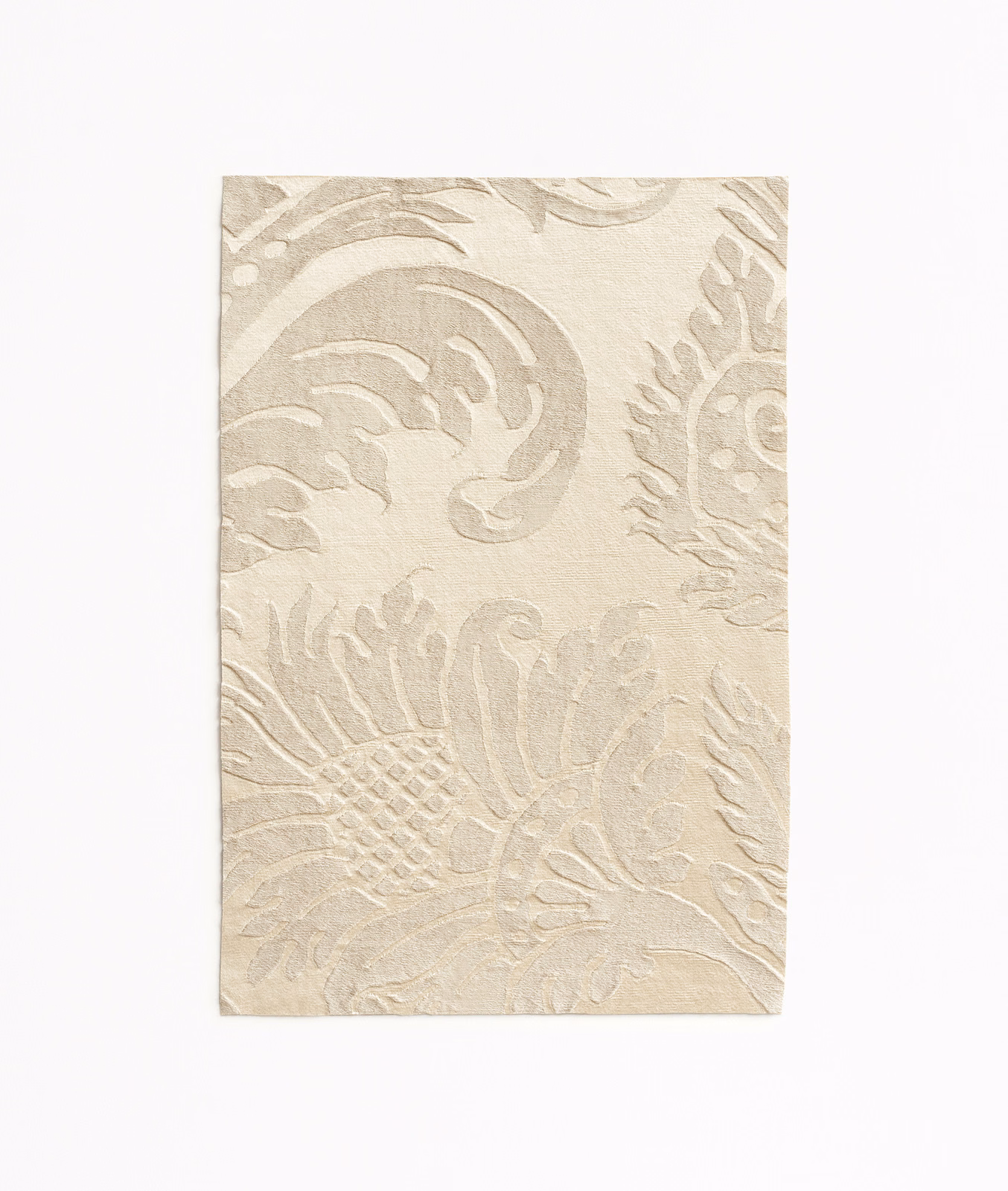 Warm ivory damask fabric with pale taupe scrolling leaves and floral motifs