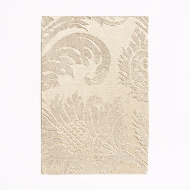 Warm ivory damask fabric with pale taupe scrolling leaves and floral motifs