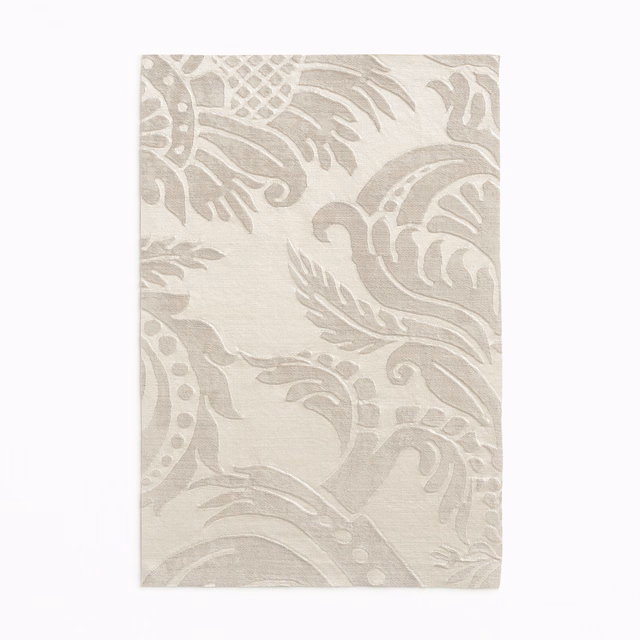 Pale taupe damask swatch with softly raised scrolling motifs and a linen-like texture