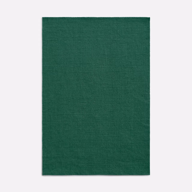 Deep forest-green curtain fabric with a fine, subtly crosshatched woven texture