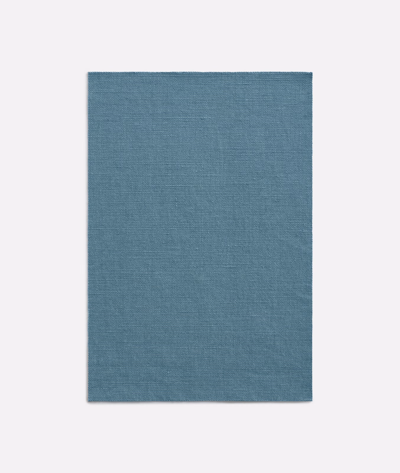 Muted denim-blue curtain fabric with a fine, even horizontal woven texture