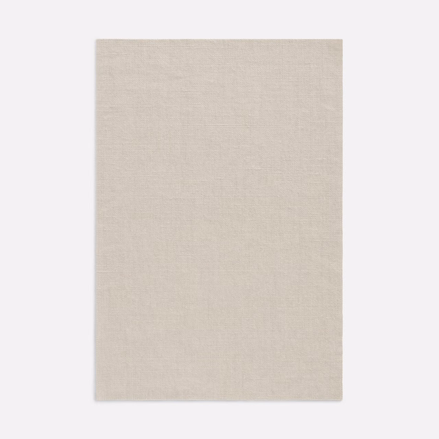 Pale stone-beige woven curtain fabric with a subtly slubbed surface