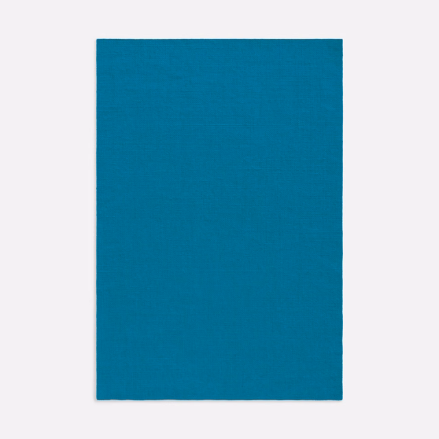 Saturated teal-blue cloth with a fine, subtly irregular woven texture