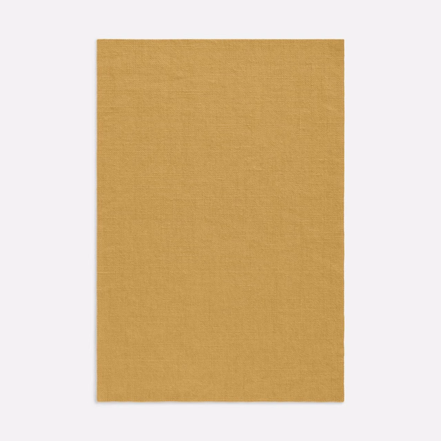 Warm mustard-gold curtain fabric with a fine, softly textured woven surface