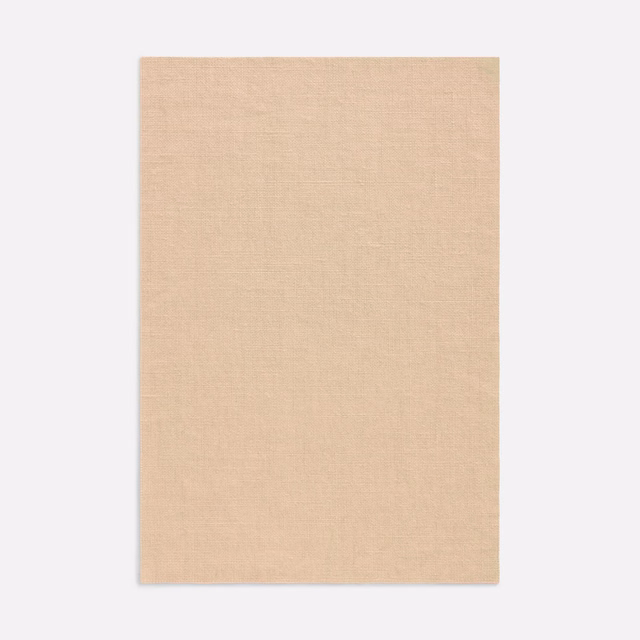 Pale salmon-peach curtain fabric with a fine, subtly crosshatched plain weave