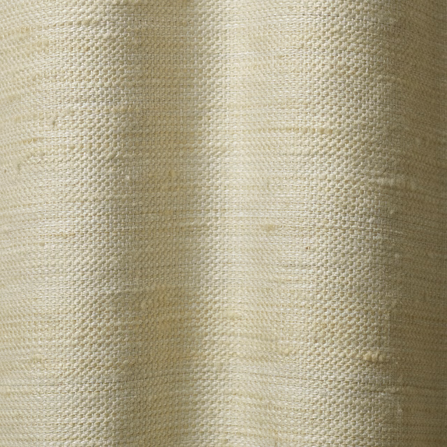 Pale ivory woven curtain fabric with softly irregular texture and vertical fold shading