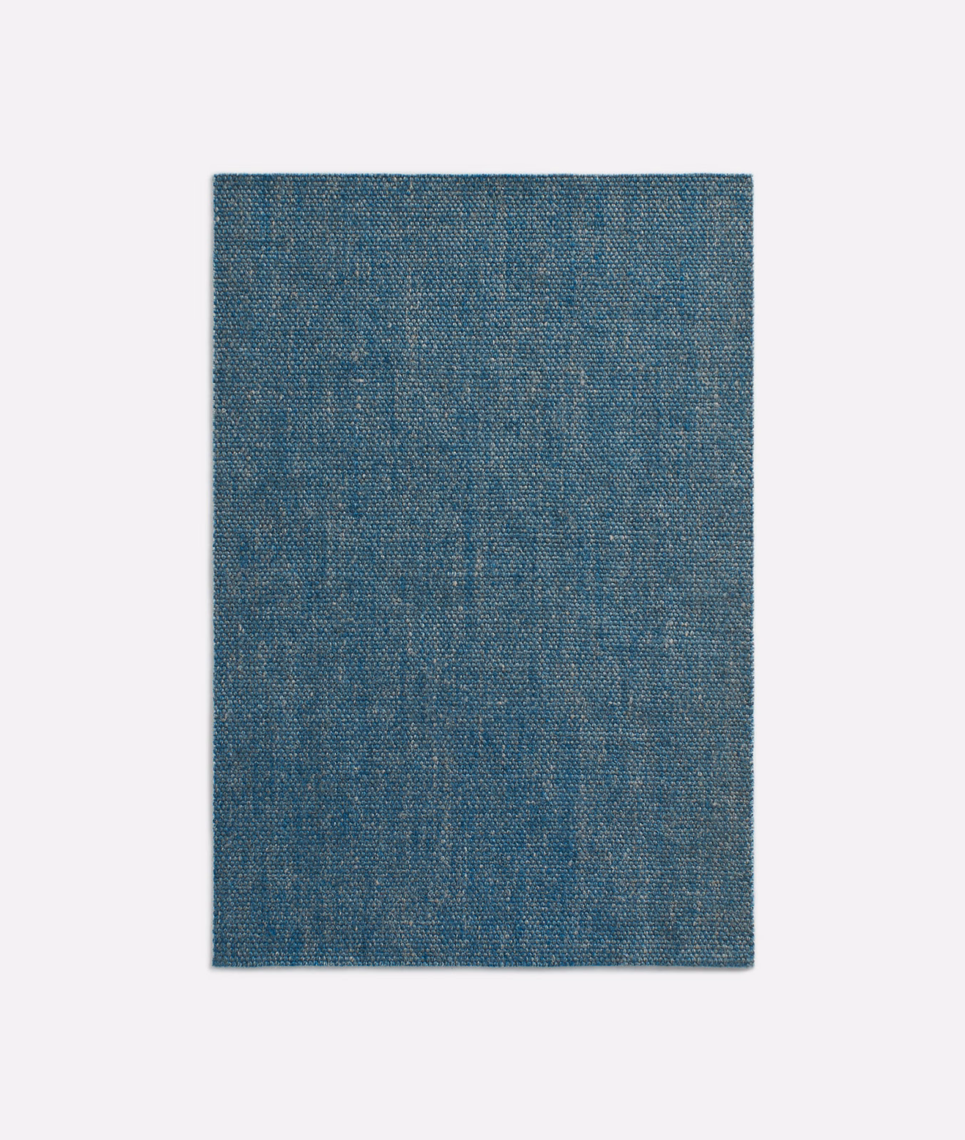 Muted denim-blue woven curtain fabric with fine mottled texture