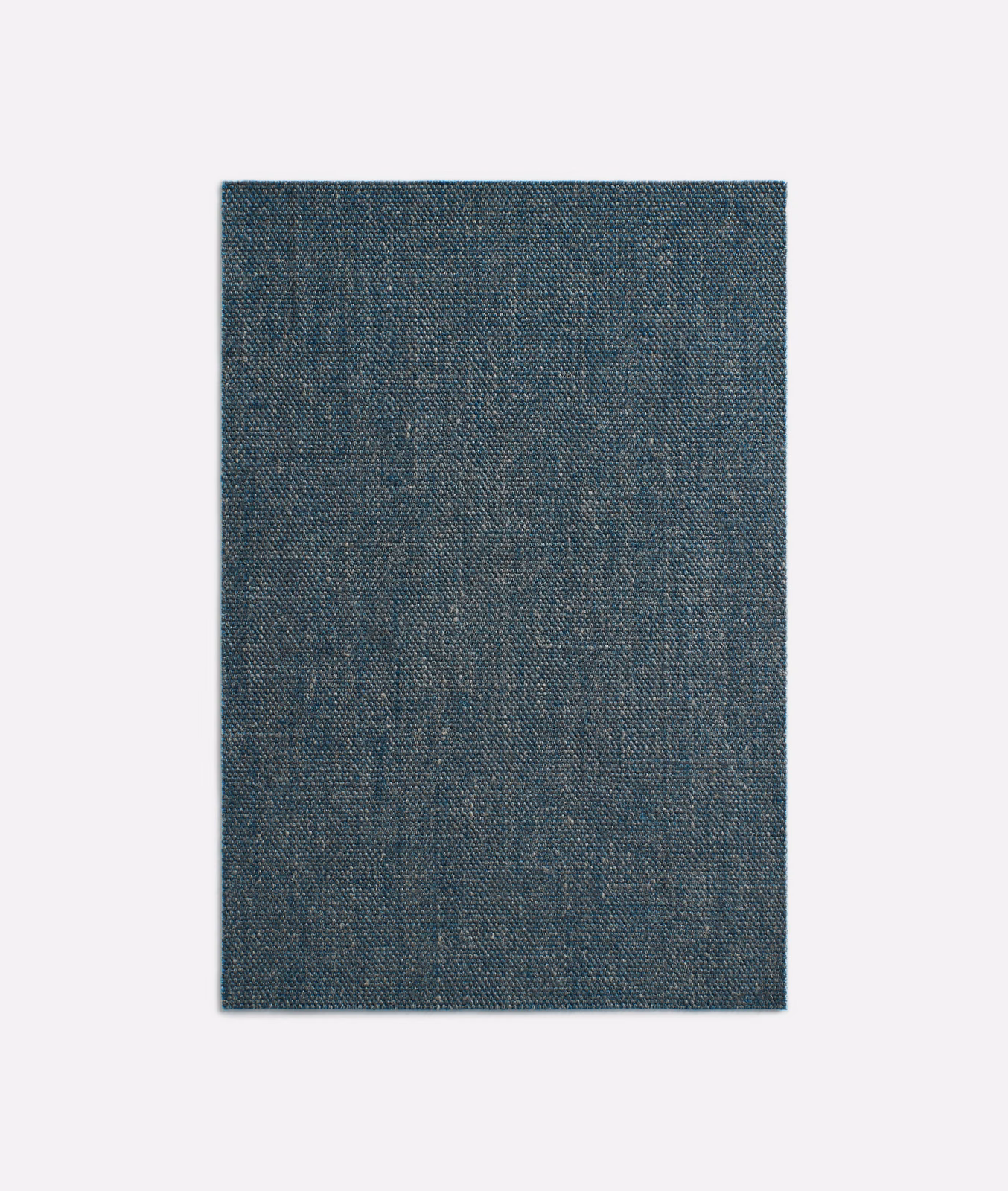 Deep indigo textile with a fine mottled woven surface and subtle blue-grey variation