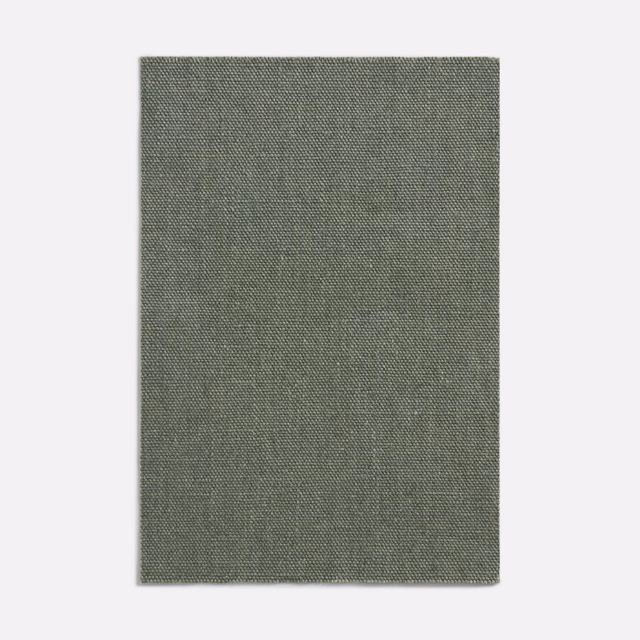 Muted olive-grey woven curtain fabric with a fine, quietly textured surface