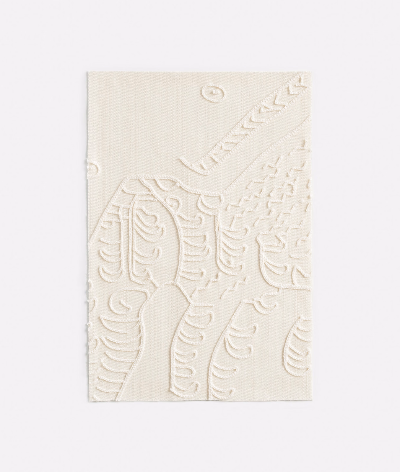 Warm ivory woven swatch with raised scrolling botanical embroidery and small loop details