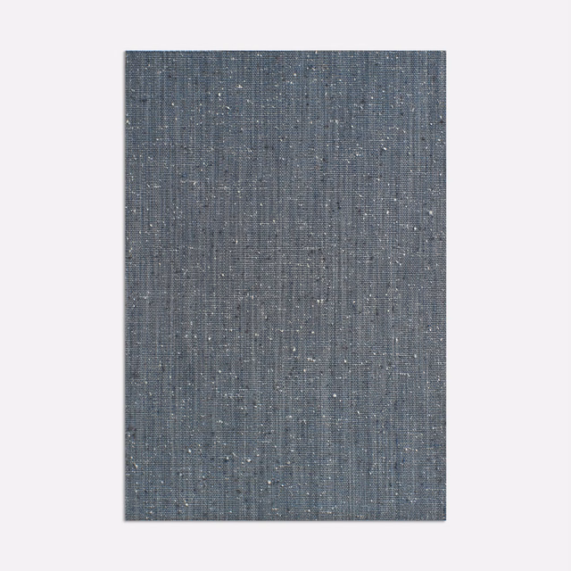 Cool blue-grey woven curtain fabric with fine vertical lines and pale flecks
