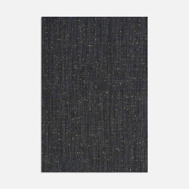 Deep charcoal curtain fabric with fine vertical ribs and subtle warm flecks