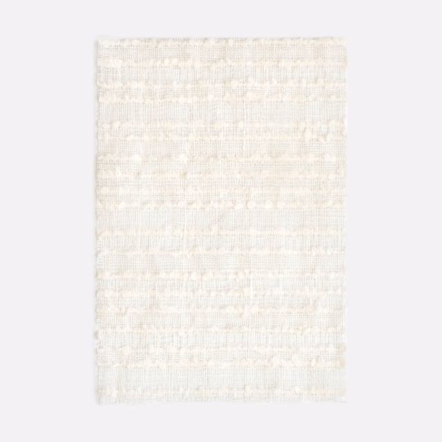 Pale ivory Whitebloom swatch with softly ridged horizontal woven bands