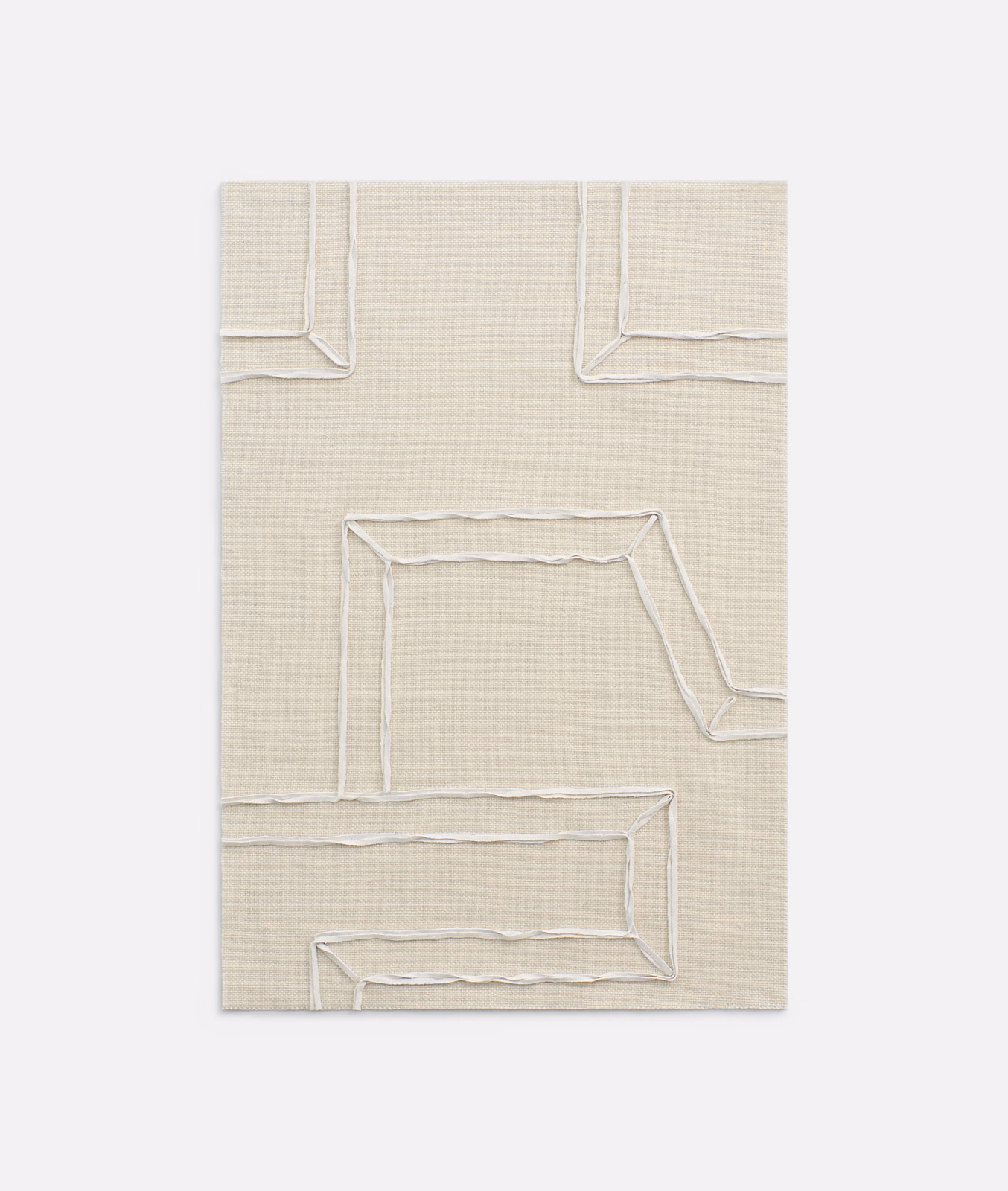 Warm ivory woven fabric with raised, irregular angular outlines catching the light
