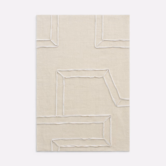 Warm ivory woven fabric with raised, irregular angular outlines catching the light