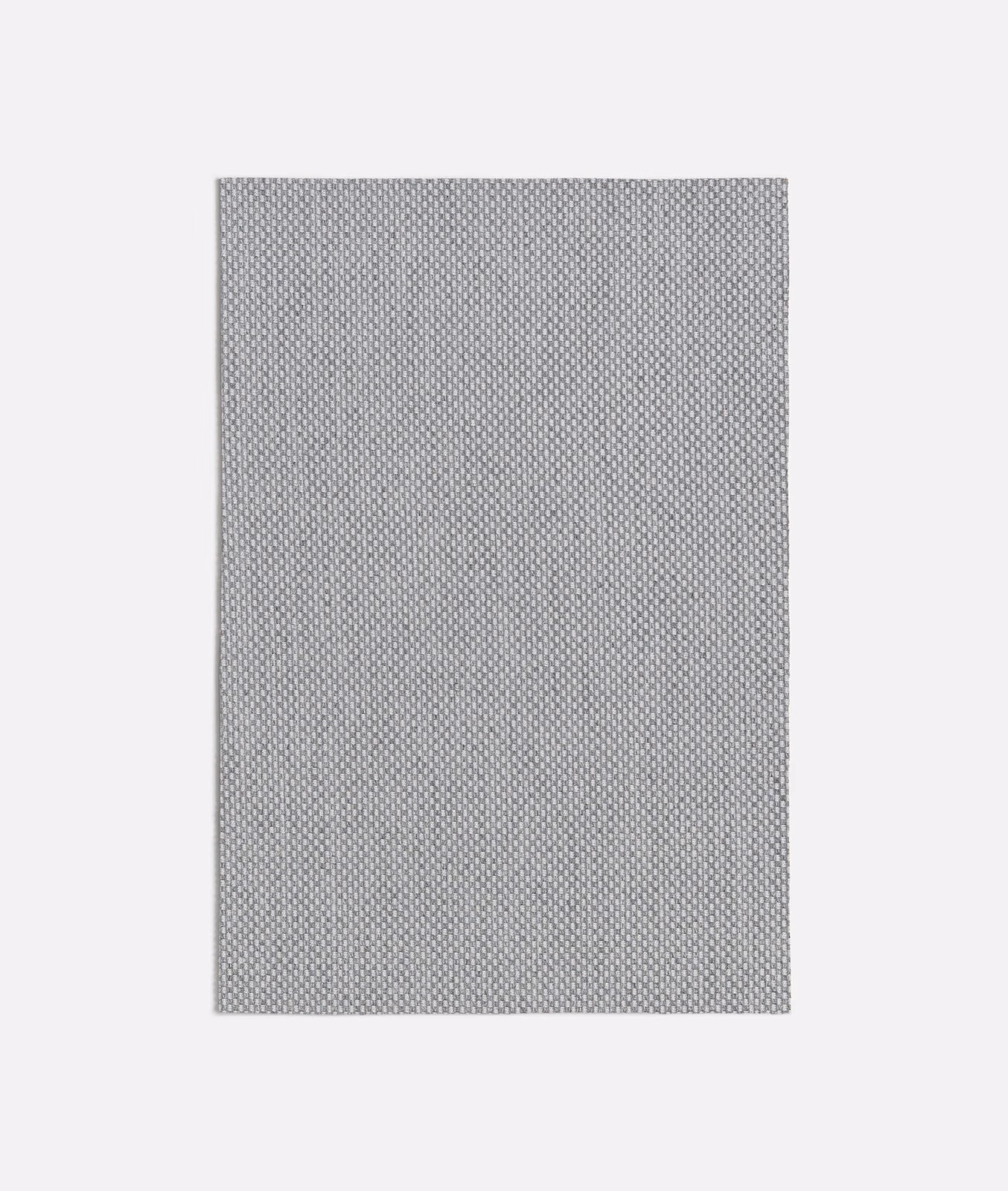 Cool mid grey fabric with a tightly repeated small geometric woven texture