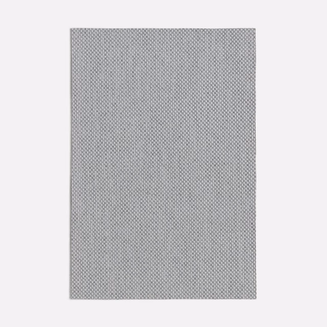 Cool mid grey fabric with a tightly repeated small geometric woven texture