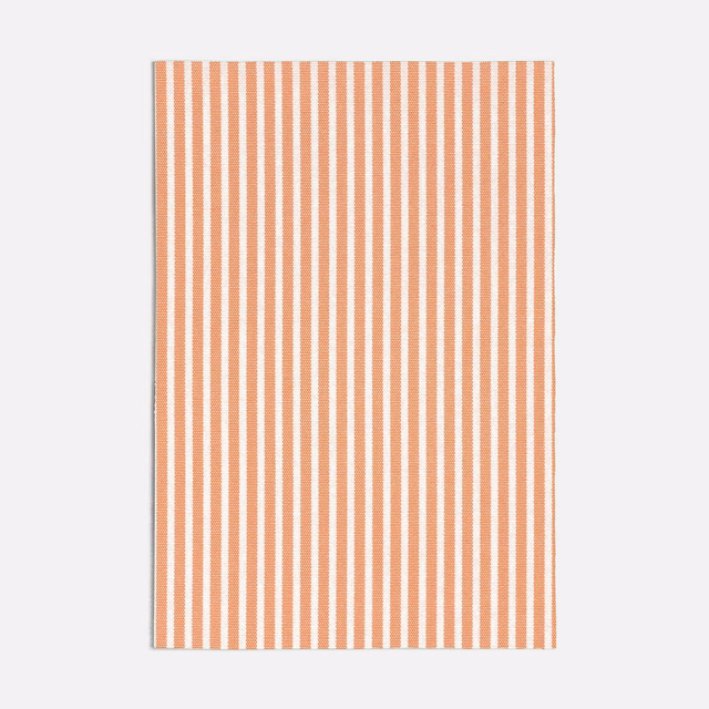 Warm peach and ivory pinstripes with a softly textured woven surface