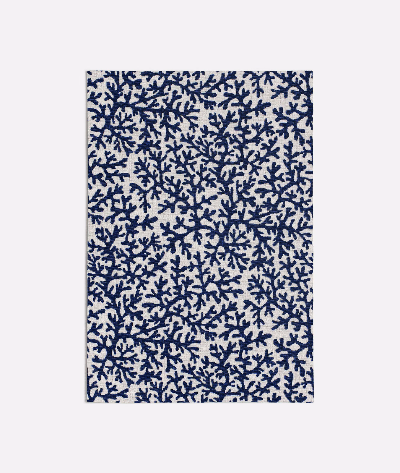 Cream fabric with dense ink-blue branching coral motif in a small-scale repeat
