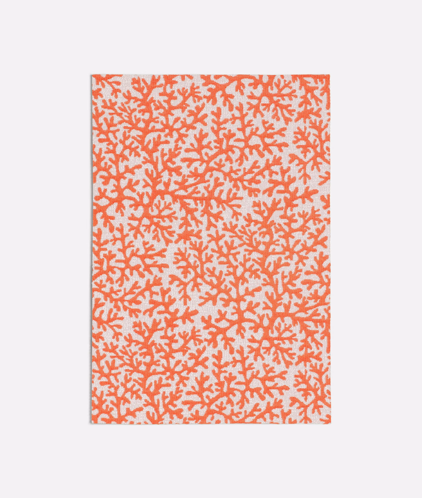 Warm coral branching coral motif scattered across a pale cream fabric ground